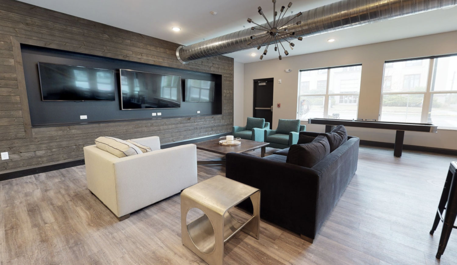 Spacious community room with tvs and couches