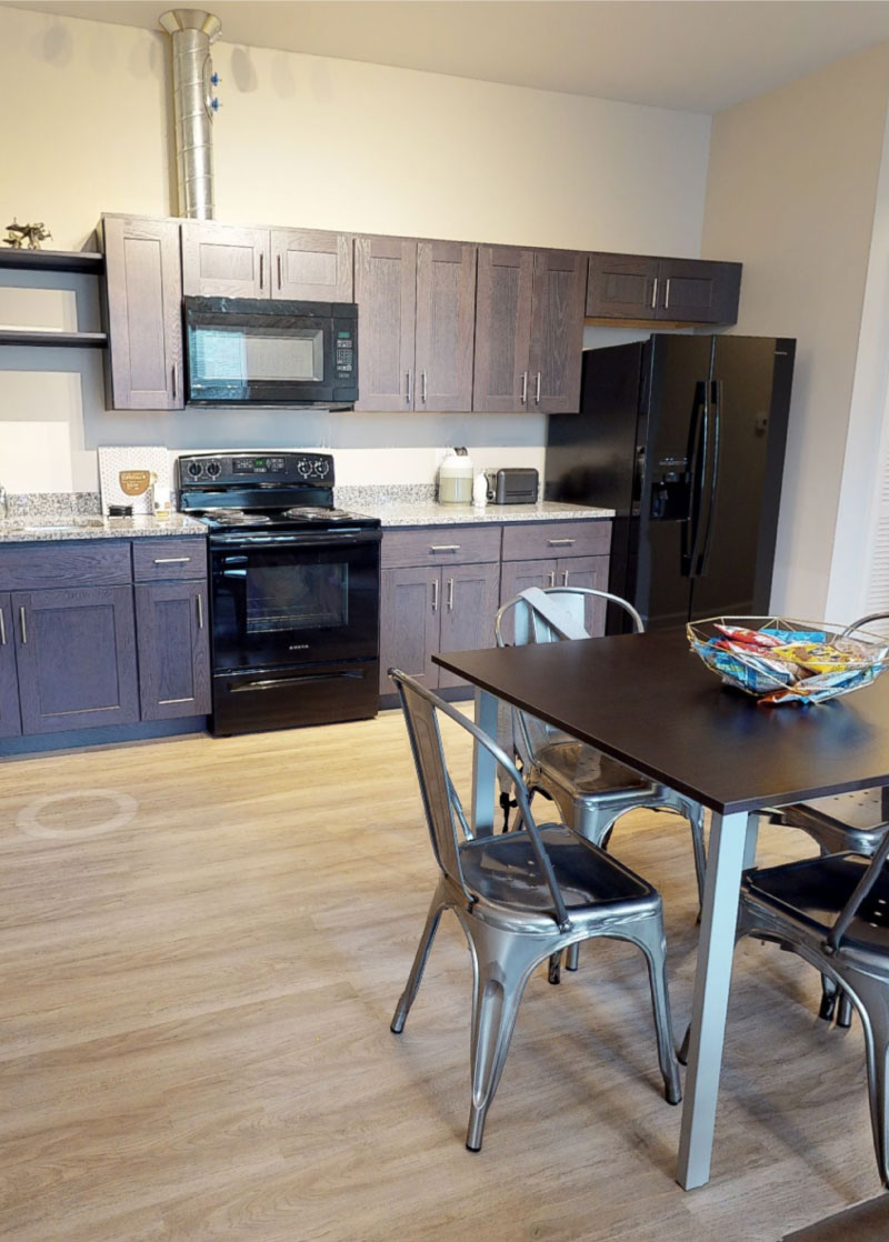 Kitchen with table, chairs and wood-like flooring